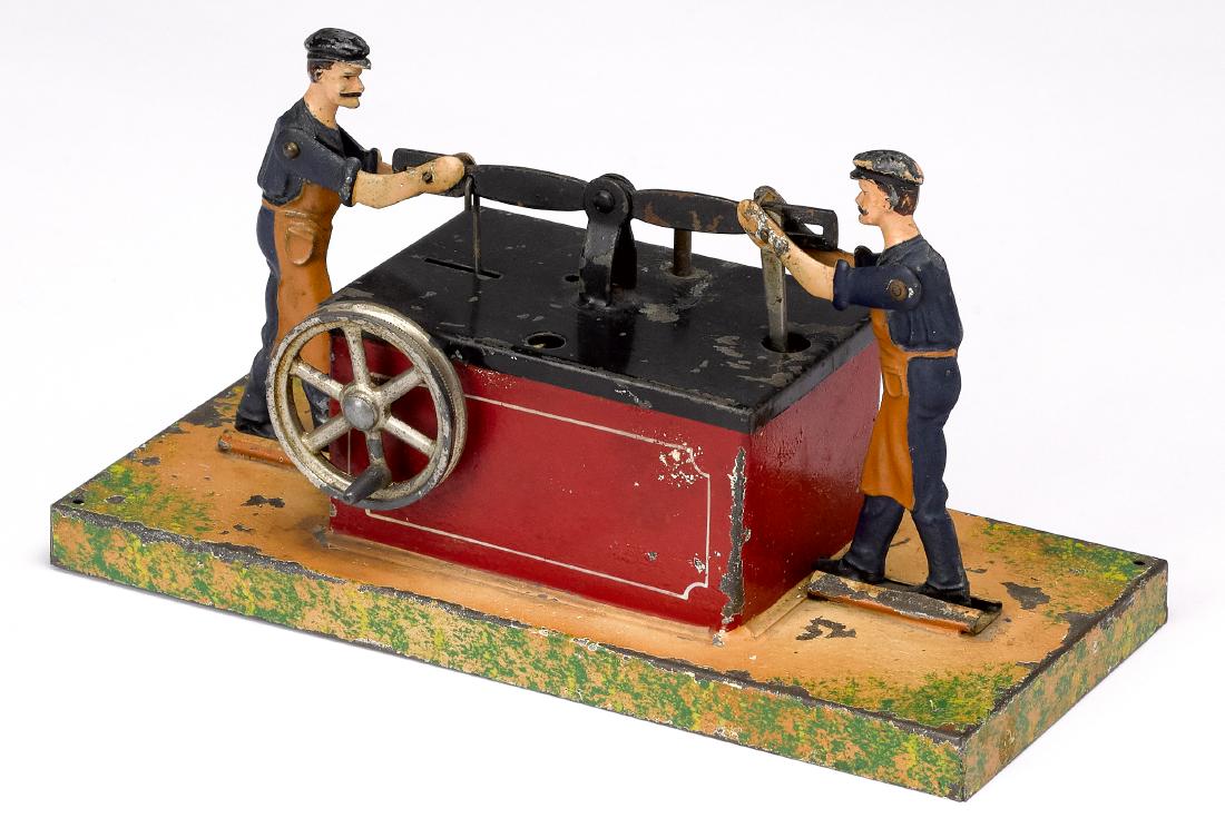 Doll painted tin at pump steam toy accessory: Doll painted tin at pump steam toy accessory, #927, 7'' w. Pictured in Morton A. Hirschberg Steam Toys - A Symphony in Motion, page 117. Provenance: Morton A. Hirschberg Steam Toy Collection