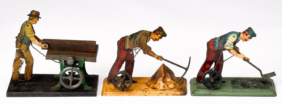 Three tin lithograph workmen steam toy accessories: Three tin lithograph workmen steam toy accessories, to include a man shoveling coal, a man with pick-axe and a man at circular saw, tallest - 5 1/4''. Provenance: Morton A. Hirschberg Steam Toy Collec