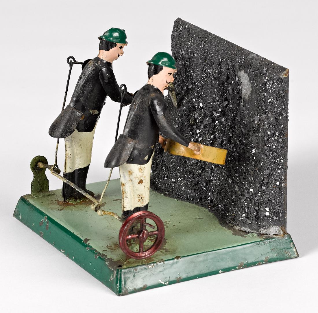 Painted tin miners steam toy accessory: Painted tin miners steam toy accessory, probably Becker, 4'' h., 5 3/8'' w. Provenance: Morton A. Hirschberg Steam Toy Collection.