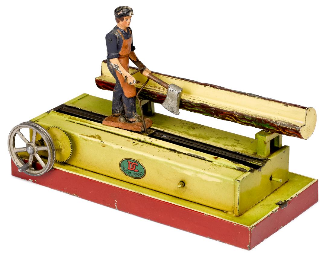Doll painted tin logger steam toy accessory: Doll painted tin logger steam toy accessory, of a man trimming a log with an axe, 5'' h., 7 1/4'' w. Pictured in Morton A. Hirschberg Steam Toys - A Symphony in Motion, page 114. Provenance: Morton A.