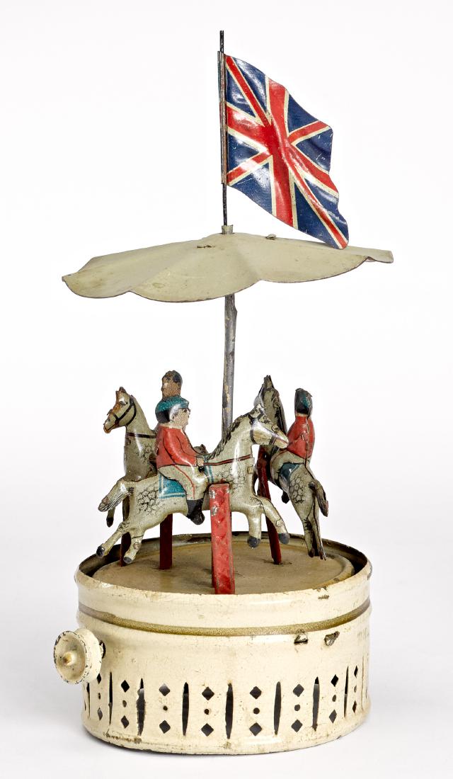 Horse carousel steam toy accessory: Painted and tin lithograph carousel steam toy accessory, with three horse and riders, 8 1/2'' h. Provenance: Morton A. Hirschberg Steam Toy Collection.
