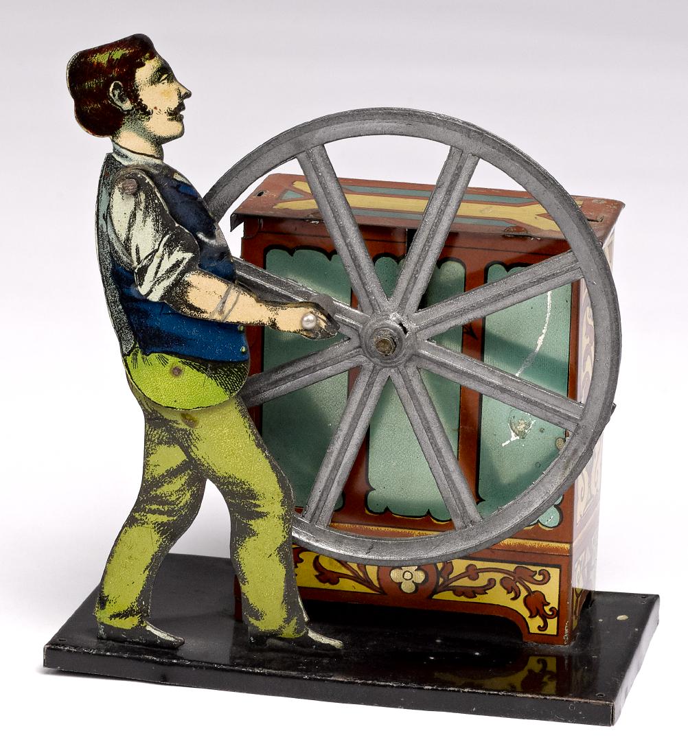Carrett musical organ grinder steam toy accessory: Carette tin lithograph musical organ grinder steam toy accessory, #657, 5 1/4'' h. Pictured in Morton A. Hirschberg Steam Toys - A Symphony in Motion, page 88. Provenance: Morton A. Hirschberg Steam T