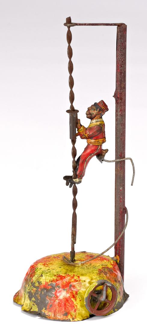 Climbing monkey steam toy accessory: Painted and lithograph tin climbing monkey steam toy accessory, 8'' h. Provenance: Morton A. Hirschberg Steam Toy Collection.
