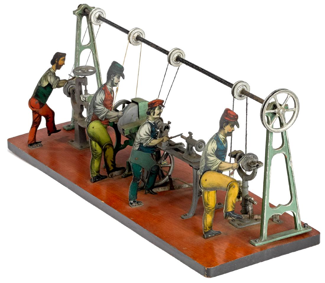 Four-man workshop steam toy accessory: Carette tin lithograph four-man workshop steam toy accessory, to include a man at a grinder, a man at a lathe, a man sharpening scissors, and a man at a drill press, mounted to a wood base, 6 1/2'' h.