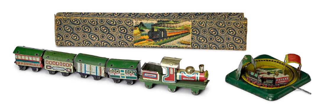 Two lithograph tin train penny toys: Two lithograph tin train penny toys, to include a Japanese five-piece train in the original box, engine and tender - 3 1/4'' l. and an animated roundabout with hand crank, 3'' w.