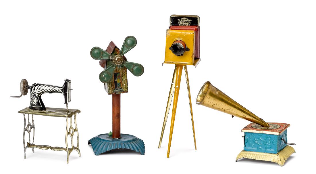 Four tin lithograph penny toys: Four tin lithograph penny toys, to include a camera on tripod, a phonograph with plink plunk music, a sewing machine, and a windmill, tallest - 5''.