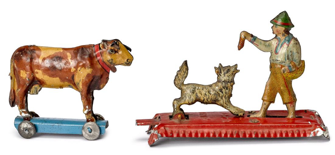 Two tin lithograph penny toys: Two tin lithograph penny toys, to include an animated Meier man feeding dog, 3 7/8'' l. and a Distler cow on platform, 2 1/2'' l.