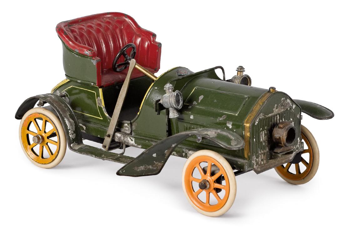 Bing clockwork two-seater open roadster: Bing painted tin clockwork two-seater open roadster, with cast lead seat, driving lights with single head light, and side lever forward and reverse controls, 9 1/2'' l.