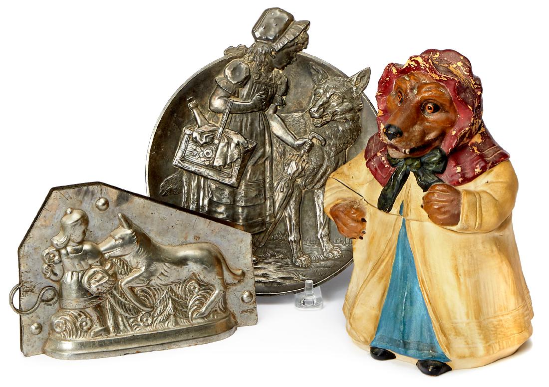 Three Little Red Riding Hood items: Three Little Red Riding Hood items, to include an embossed silver plated wall plaque, signed Lolin, 6 3/4'' dia., a chocolate mold, 6 1/4'' w. and an Austrian bisque Big Bad Wolf humidor, 8'' h.