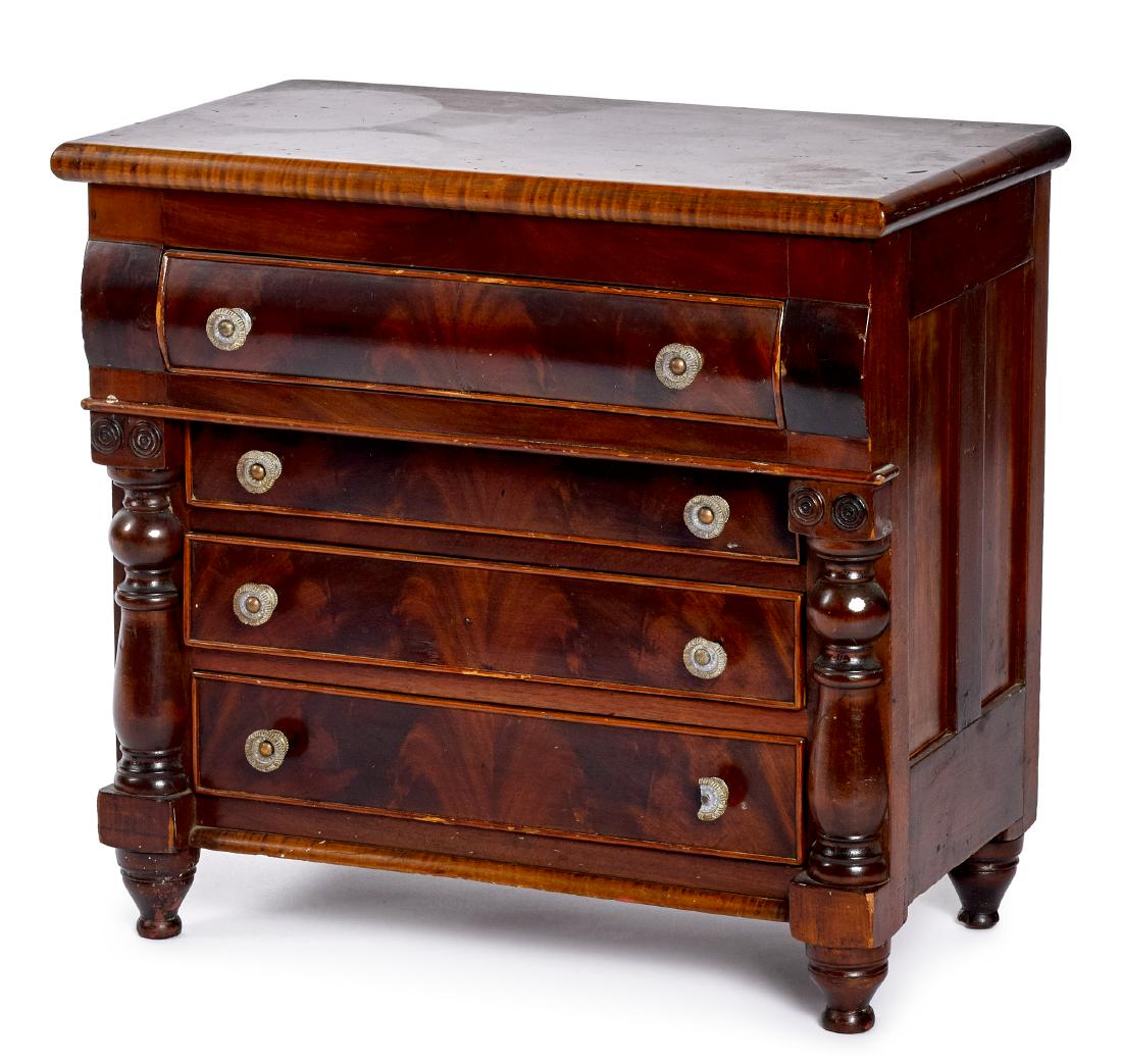 Miniature doll-size transitional chest of drawers: Miniature doll-size tiger maple, cherry and mahogany transitional chest of drawers, ca. 1840, having turned applied half columns with double circular rosettes on capitals, 19 1/4'' h., 19 1/2'' w.
