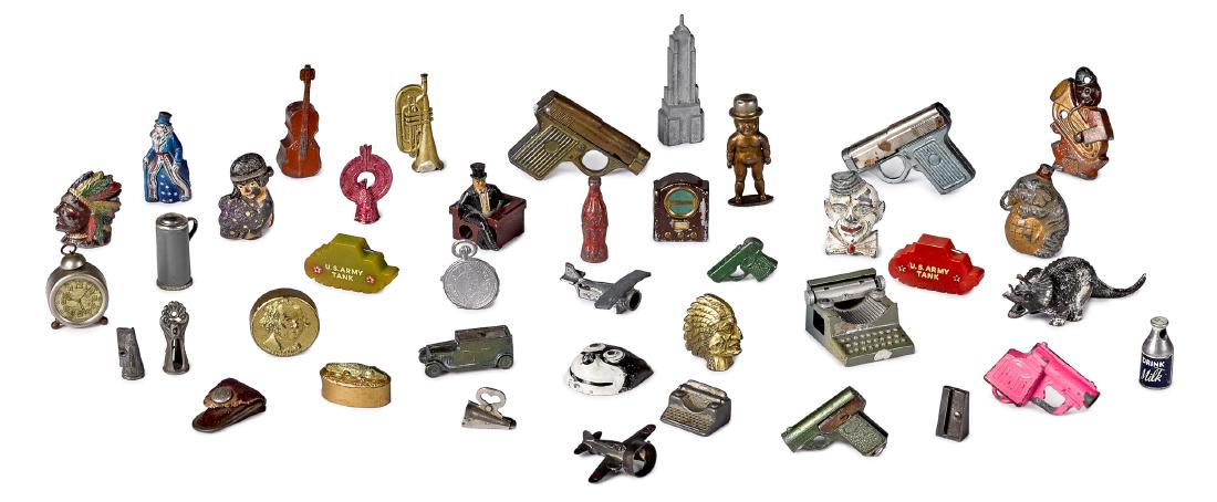 Approximately forty figural pencil sharpeners: Approximately forty figural pencil sharpeners, to include two Bakelite tanks, Felix the Cat, a Coca-Cola bottle, a clown, several guns, typewriters, cars, airplanes, a milk bottle, the Empire State bu