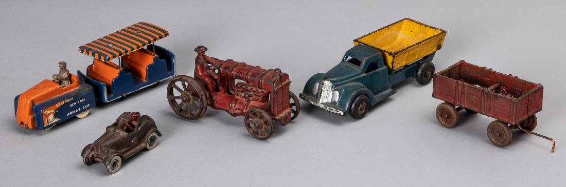 Four cast iron vehicles, etc.: Four cast iron vehicles, to include a Kilgore roadster with driver, 3 1/4'' l., an Arcade dump truck, 6 1/2'' l. and an Arcade tractor, 5'' l., and wagon, together with an Arcade New York World's Fair