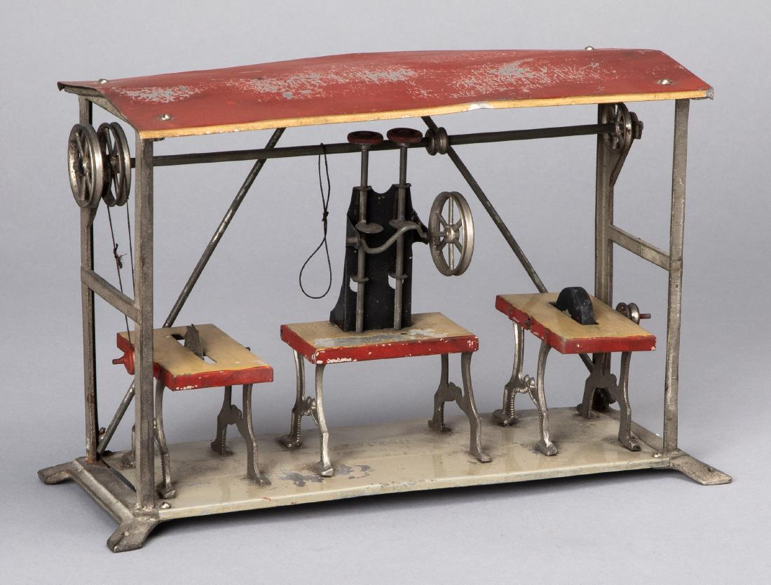 Weeden machine shop steam toy accessory: Weeden painted tin and white metal machine shop steam toy accessory, to include a table saw, a punch and grinding wheel, 7 1/2'' h., 11 1/2'' w.