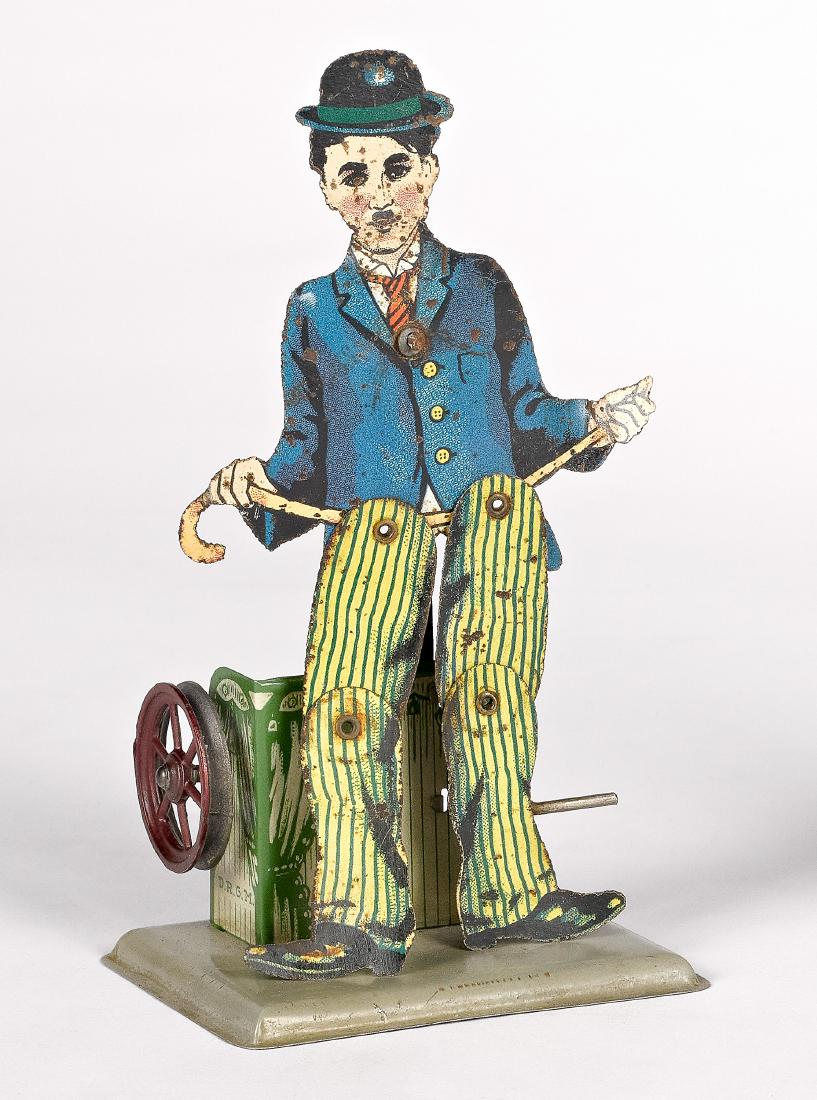 Charlie Chaplin slate dancer steam toy accessory: Wilhelm Krauss lithograph tin Charlie Chaplin slate dancer steam toy accessory, 6 1/2'' h., 3 1/2'' w. Provenance: Morton A. Hirschberg Steam Toy Collection.