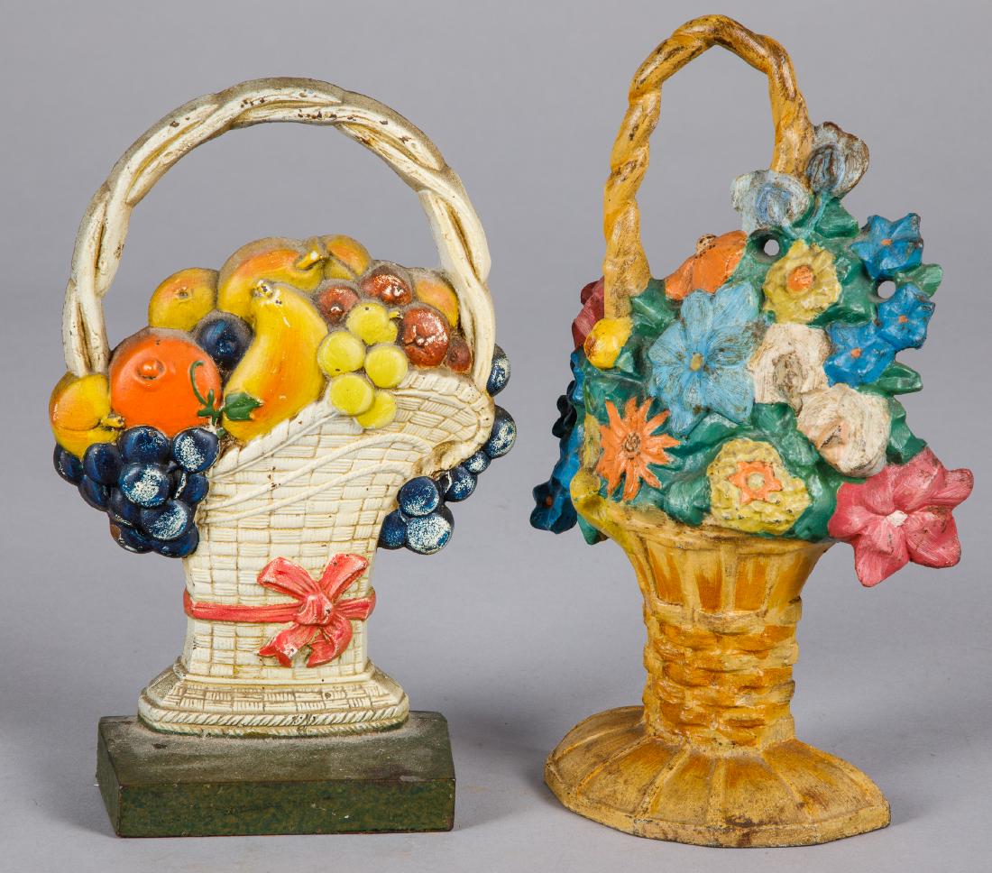 Two cast iron doorstops: Two cast iron doorstops, to include a Judd & Co fruit basket, 9 3/4'' h. and a flower basket, 10 3/4'' h.
