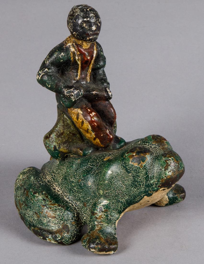 Black Americana figure on a frog doorstop: Scarce cast iron Black Americana figure on a frog doorstop, 6 1/4'' h.