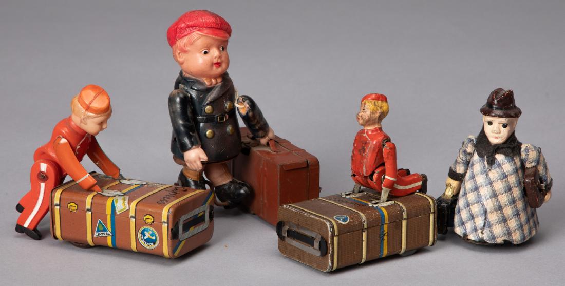 Four wind-up and friction porter toys: Four celluloid and tin wind-up and friction porter toys, tallest - 4 1/2''.