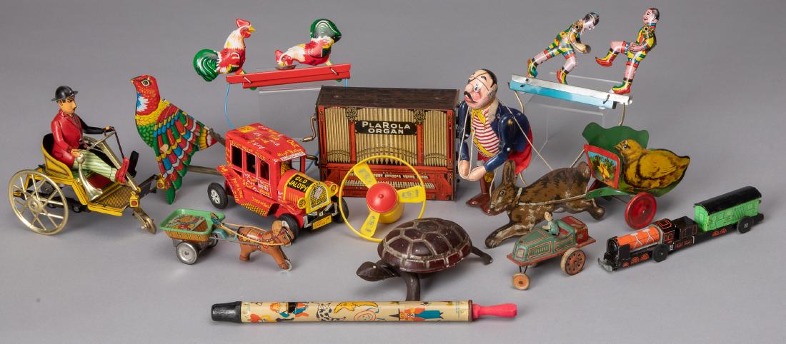 Large group of tin toys: Large group of tin toys, to include a rabbit pulled chick cart, a climbing pirate, a Paya horseless carriage, a Japanese wind-up turtle, Alps friction donkey cart, a Plarola Organ, a flapping bird, an