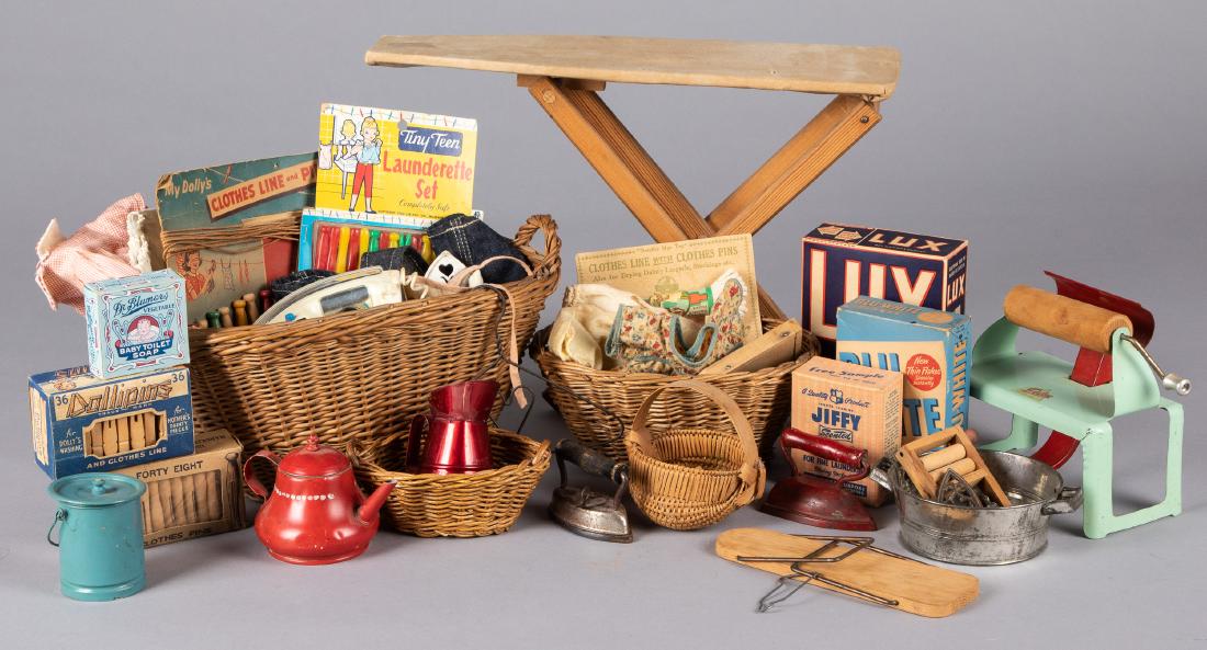 Large group of children's laundry toys: Large group of children's laundry toys, to include wicker wash baskets, soap, a wringer, wooden ironing board, clothespins, etc., largest basket - 7'' h.