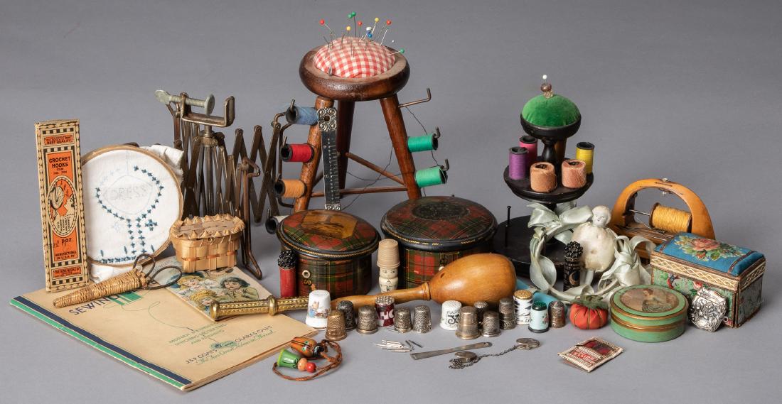 Group of sewing accessories: Group of sewing accessories, to include pin cushions, a thread case, needle cases, thimbles; some sterling and enameled, a line winder, etc.
