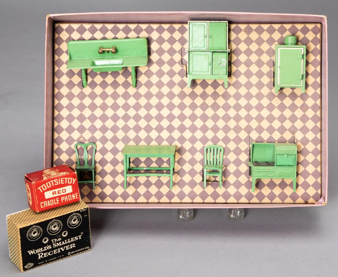 Three boxed pieces of Tootsietoy doll furniture: Three boxed Tootsietoy doll furniture, to include a cradle phone, The Worlds Smallest Receiver with child on toilet, and a kitchen set.