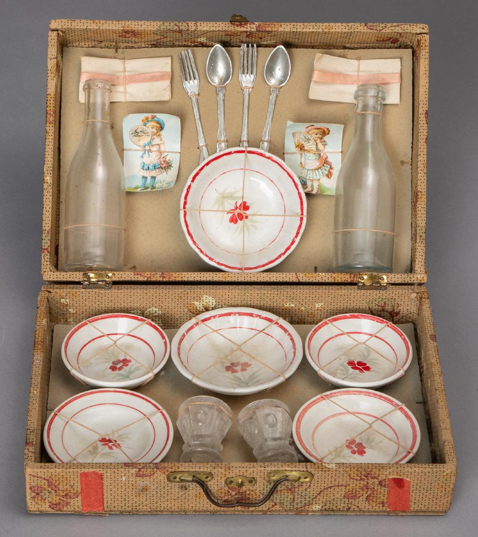 Doll's porcelain and glass picnic set: Doll's porcelain and glass picnic set, in its original suitcase box, 10'' w.