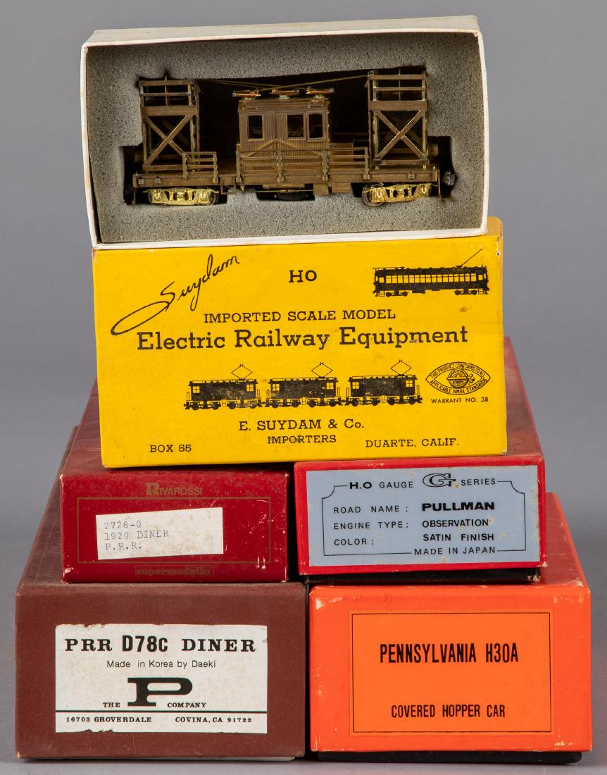 Five brass HO scale train cars and locomotives: Five brass HO scale train cars and locomotives, in the original boxes, to include two Suydam & Co. wire greaser tower cars, a P. E. Electra switcher, a Nickel Plate Productions Pennsylvania H20A cover