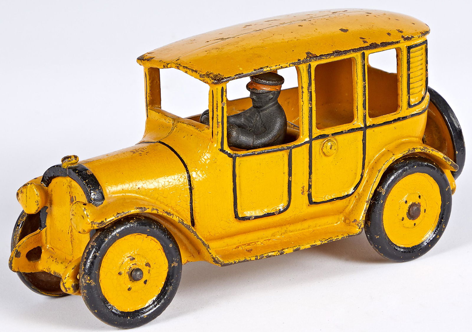 Hubley cast iron yellow cab: Hubley cast iron yellow cab, with painted cast iron driver, with an actual yellow paint rather than orange that is typically seen, 8 1/4'' l. Provenance: Provenance: Collection of Bill and Stevie Wear
