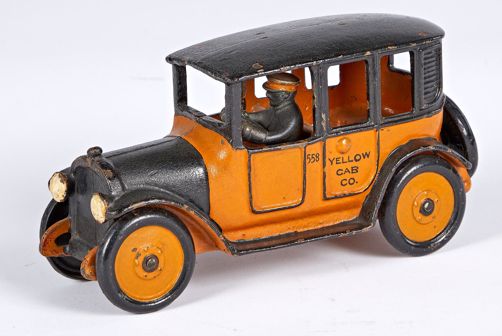 Hubley Yellow Cab Co. 558 cab: Hubley cast iron Yellow Cab Co. 558 cab, with painted cast iron driver, 8'' l. Provenance: Collection of Bill and Stevie Weart.