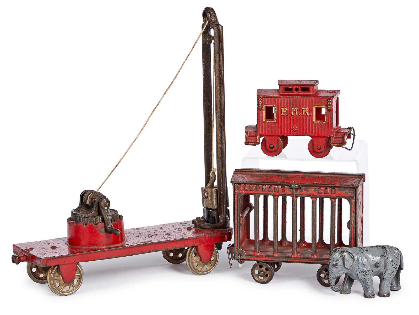 Ives cast iron Greatest Show on Earth elephant ca: Ives cast iron Greatest Show on Earth elephant train car, with elephant, 6'' l., together with an Arcade cast iron pile driver train car, 10'' l. and a PRR caboose, 4 3/4'' l. Provenance: Collection o