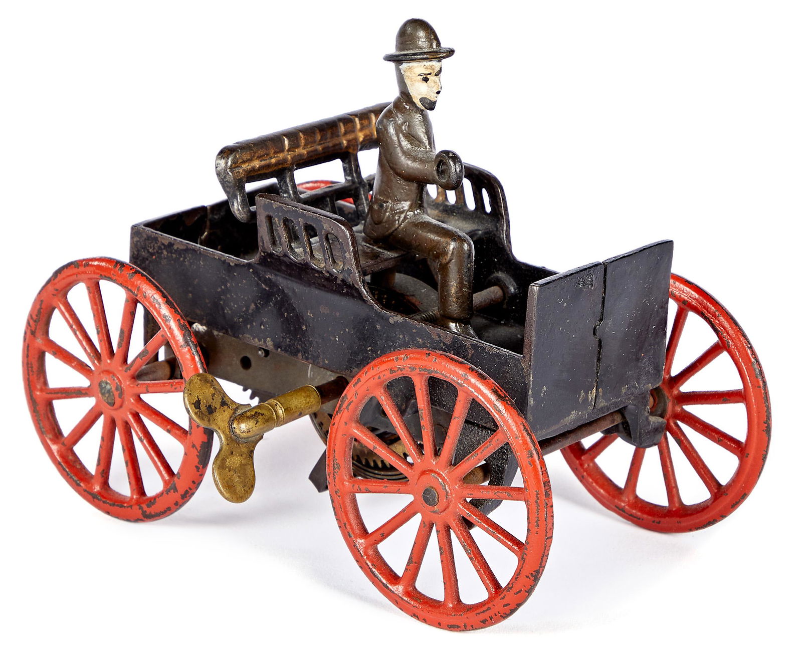 Ives cast iron horseless carriage: Ives cast iron wind-up horseless carriage, with cast iron driver, 6'' l. Provenance: Collection of Bill and Stevie Weart.