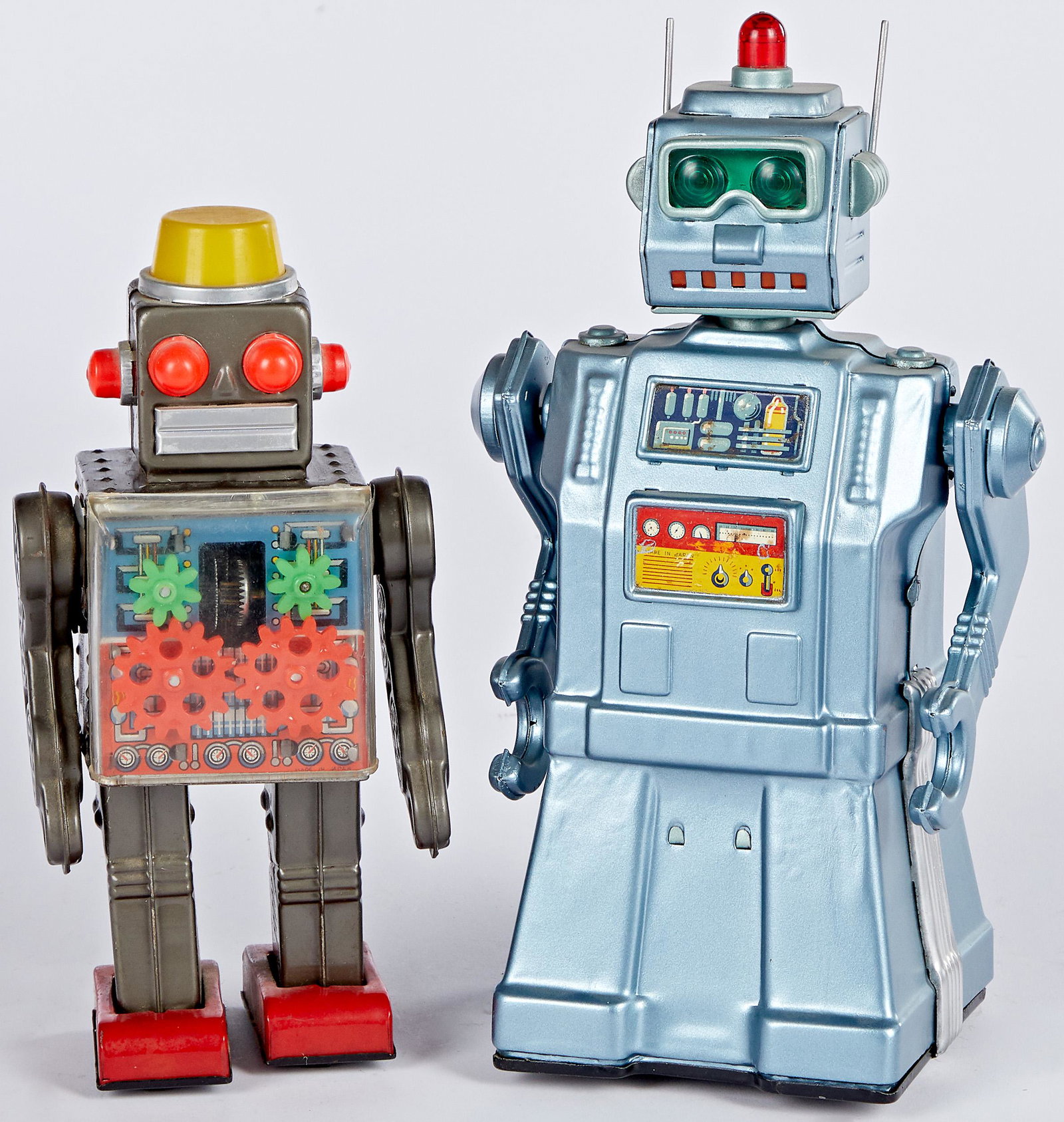 Two Japanese tin litho battery operated robots: Two Japanese tin lithograph battery operated robots, to include a Yonezawa, 10 1/2'' h. and an Engine Robot, 8 3/4'' h.