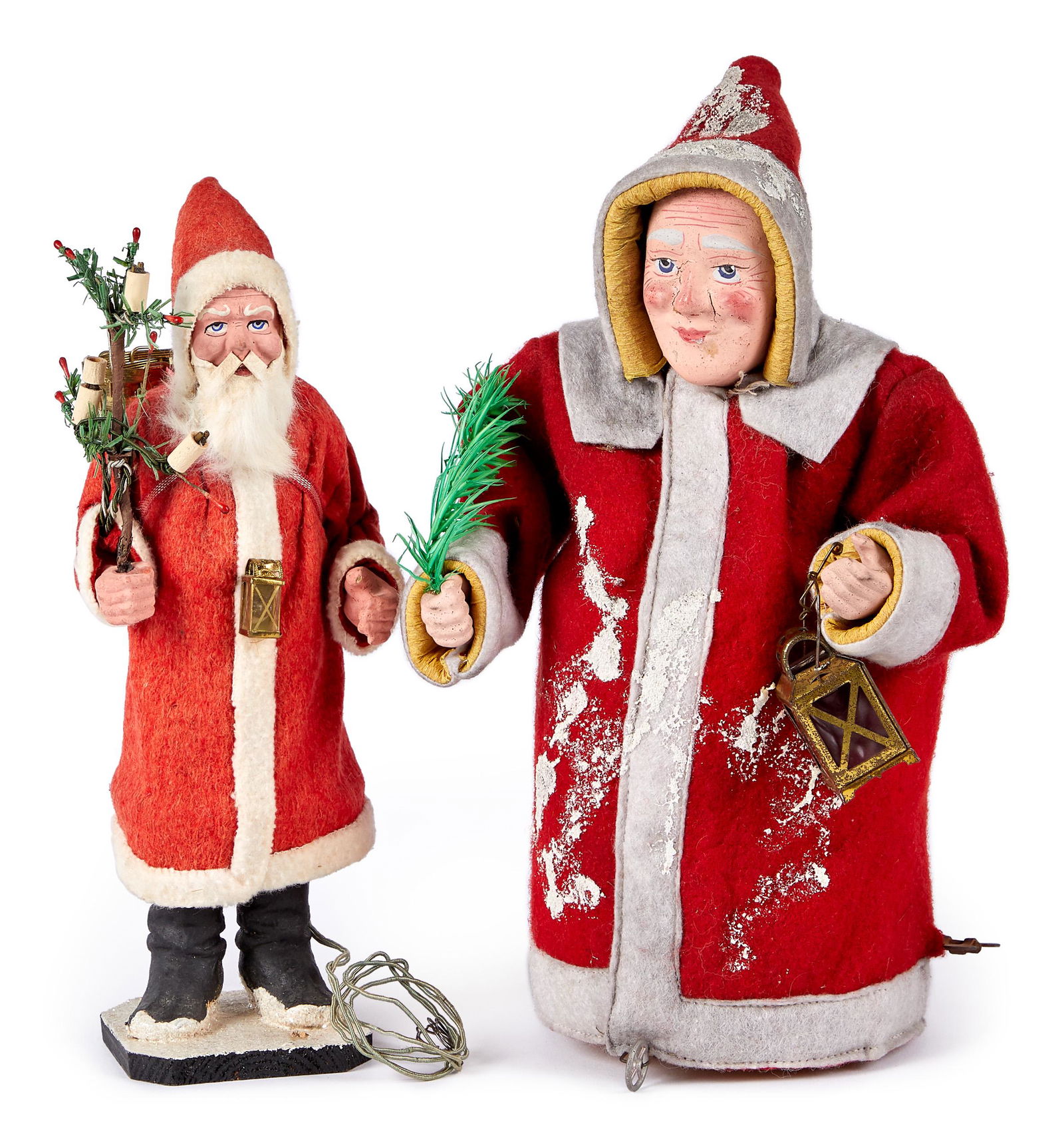 Two German composition Santa Claus figures: Two German composition Santa Claus figures, to include an electrified Santa with feather tree, and small lantern on chest with bulb, 9 1/2'' h., and a clockwork figure on wheels, with lantern and feat