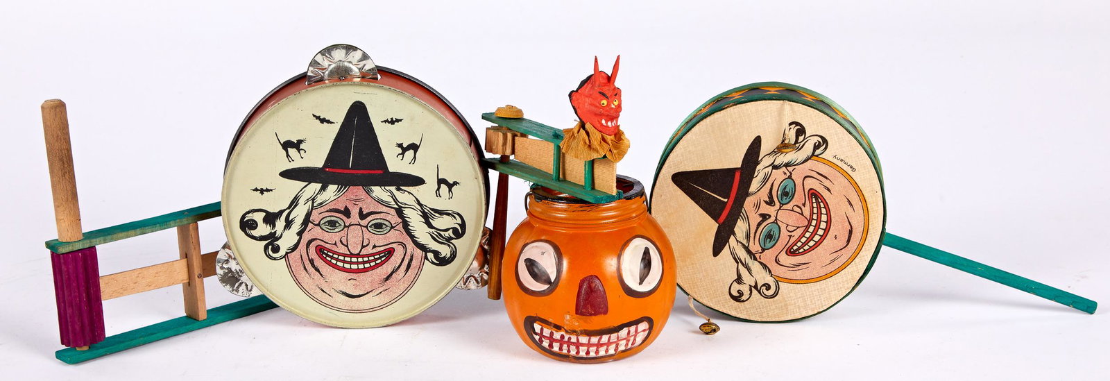Painted glass Halloween lantern and noisemakers: Painted glass Halloween lantern and noisemakers, to include an embossed glass jack-o'-lantern, 4'' h., a German paper tambourine and a tin lithograph tambourine, a figural devil head rattle, and a pai