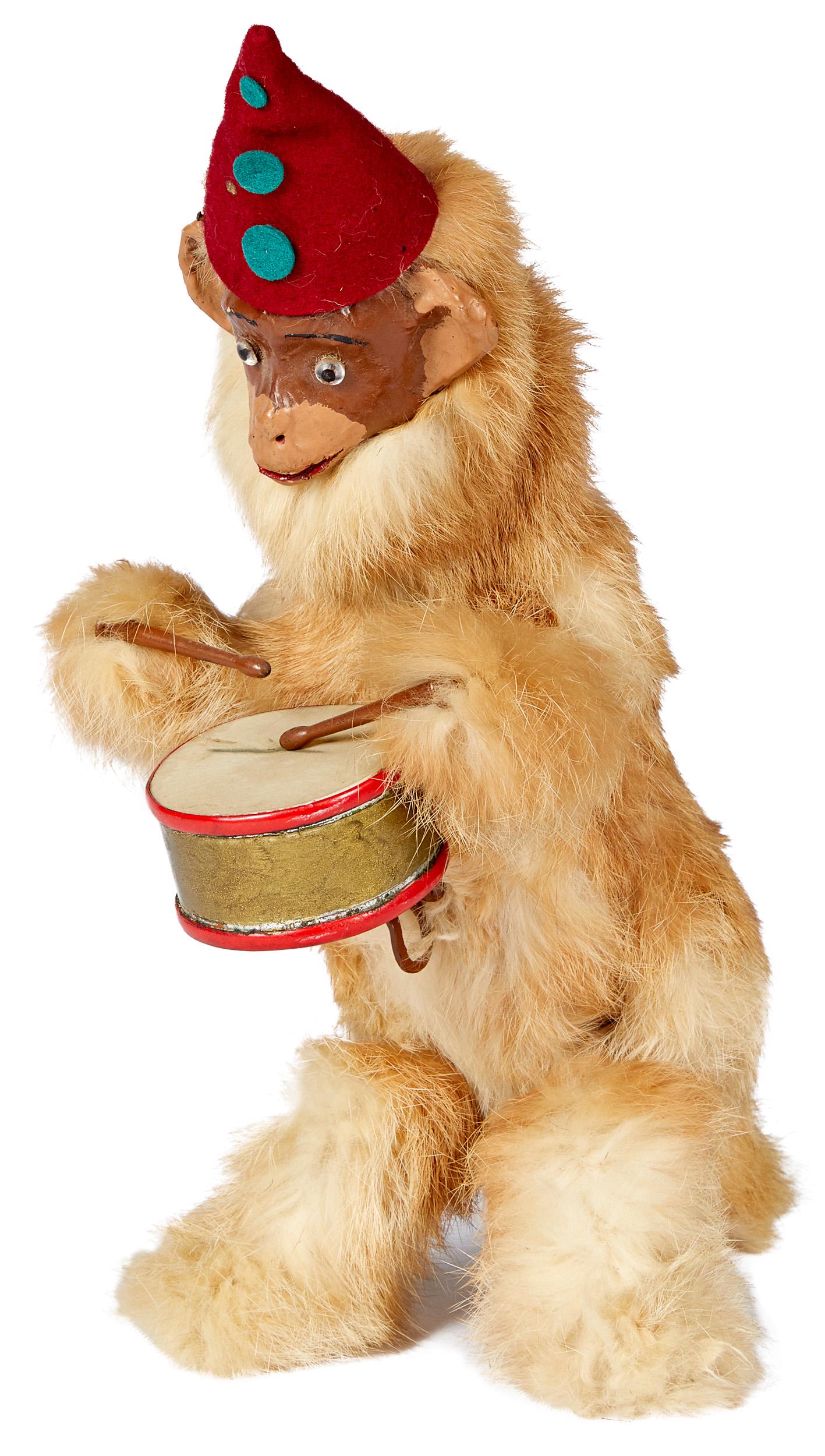 Wind-up fur covered monkey: Wind-up fur covered monkey, with composition face and felt hat, 13'' h.