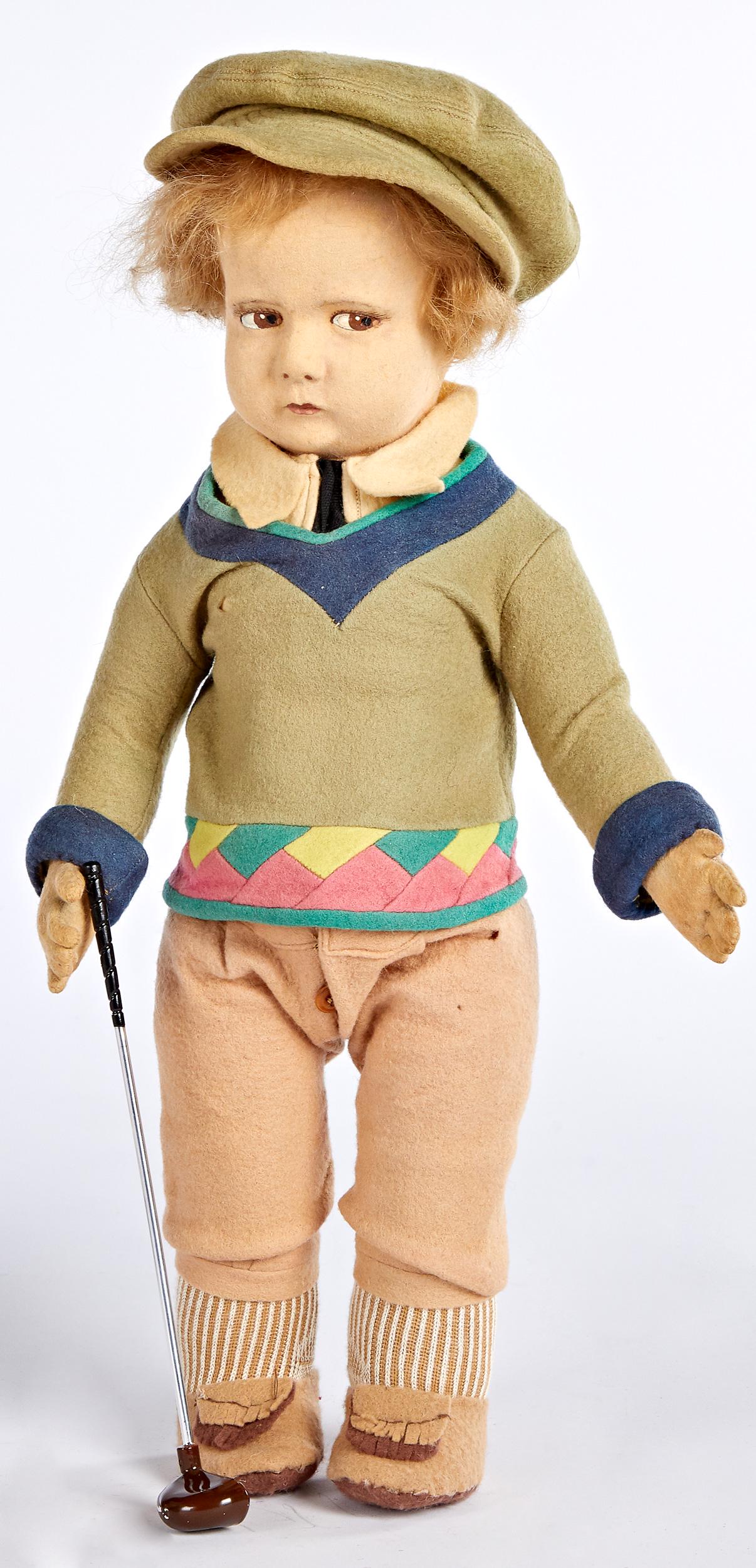 Lenci sport series golfer felt doll: Lenci sport series golfer felt doll, with hollow torso, swivel head, painted side glancing almond shaped eyes, closed mouth, in original clothing, 17'' h.