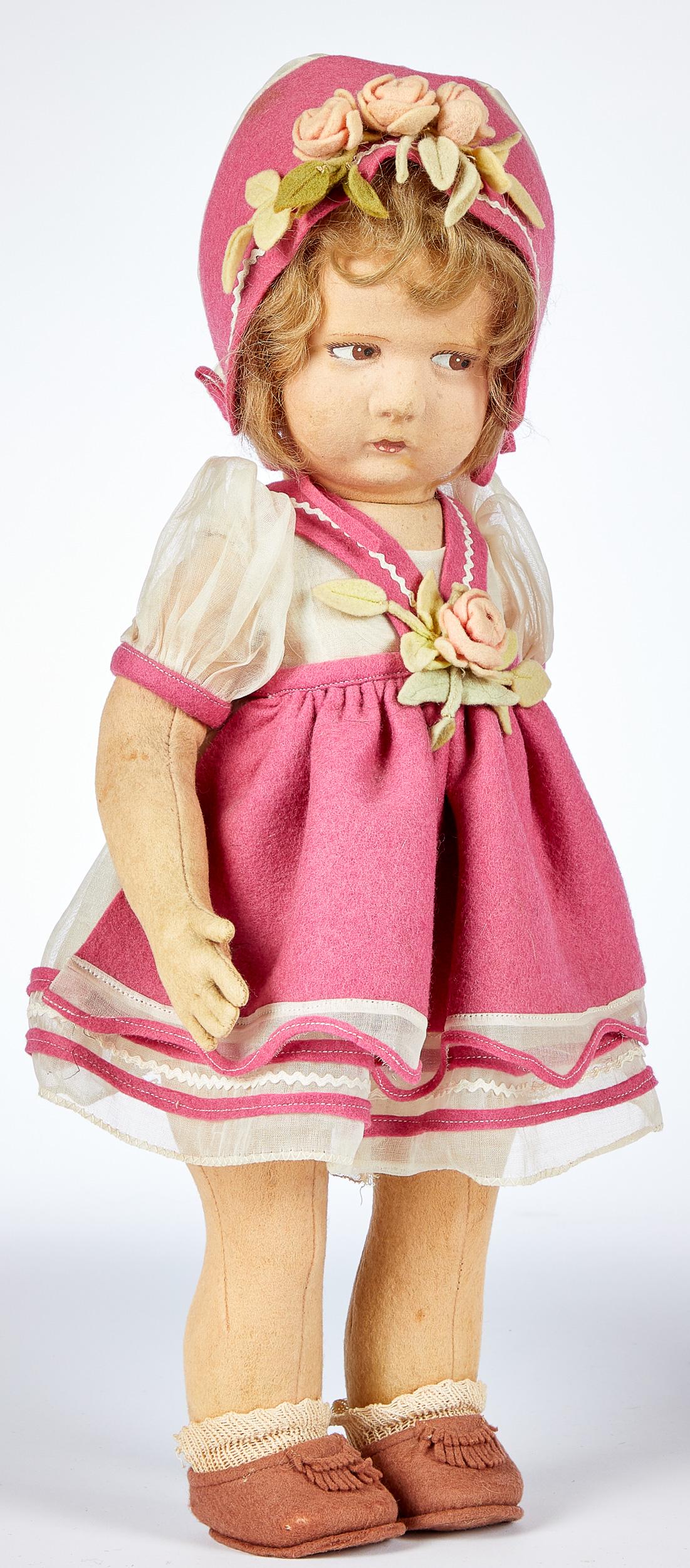 Lenci pouty face felt doll: Lenci pouty face felt doll, with hollow torso, swivel head, painted side glancing eyes, closed mouth, in an organdy and pink felt outfit with matching hat and quilted bottom shoes, 17'' h.