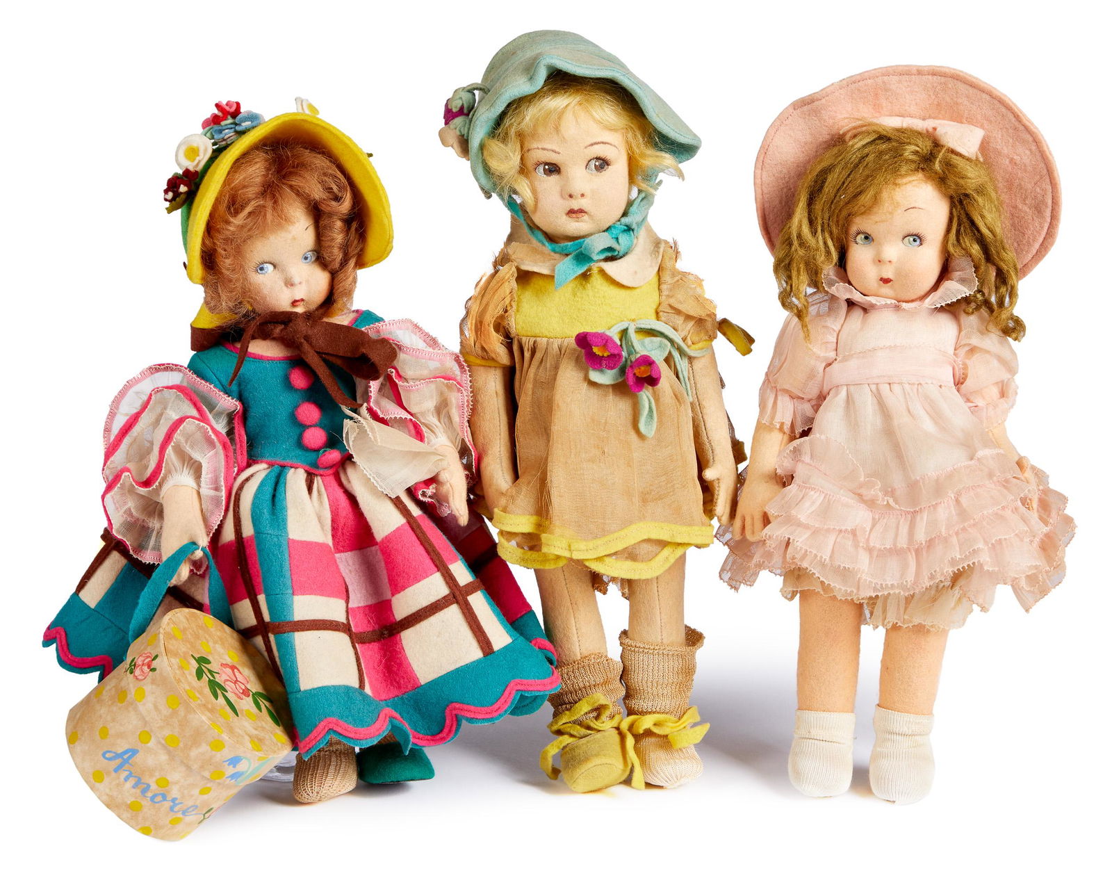 Three Lenci felt dolls: Three Lenci felt dolls, with painted side glancing eyes and closed mouths, with felt and organdy outfits, 11 1/2 h.'' and 12'' h.