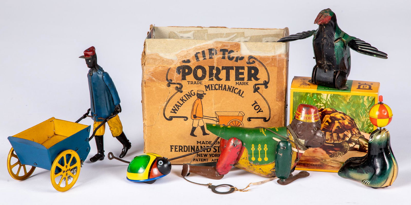 Group of tin wind-up toys: Group of tin wind-up toys, to include a Strauss climbing monkey, Lehmann Susi turtle in the original box, Lehmann seal, Lehmann lady bug, Strauss Tip Top Porter, with remains of original box, and a Fr