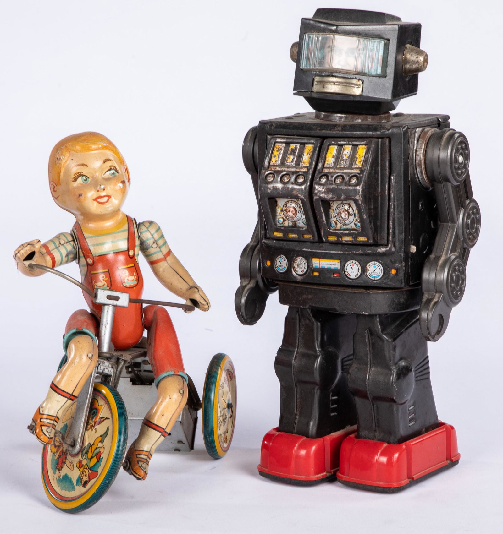 Unique Art tin lithograph Kiddy Cyclist, etc.: Unique Art tin lithograph wind-up Kiddy Cyclist, 9'' h., together with a Japanese tin battery operated robot, 11 1/2'' h.