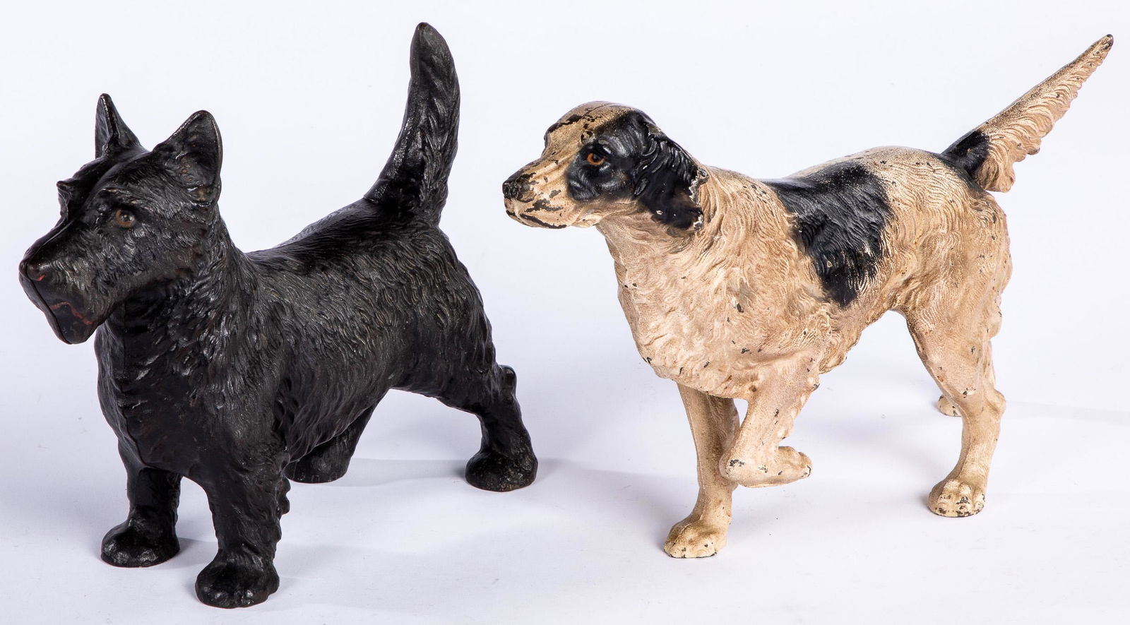 Two cast iron doorstops: Two cast iron doorstops, to include a setter, 15 1/2'' l. and a Scottie dog, 11'' l.