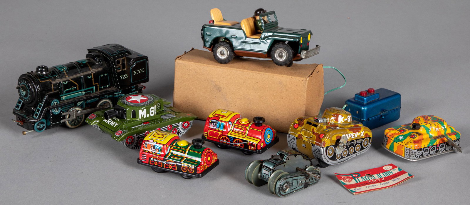 Group of Japanese tin lithograph mechanical toys: Group of Japanese tin lithograph mechanical toys, to include a battery operated train locomotive, remote control Jeep, and wind-up tanks, train - 7'' l.