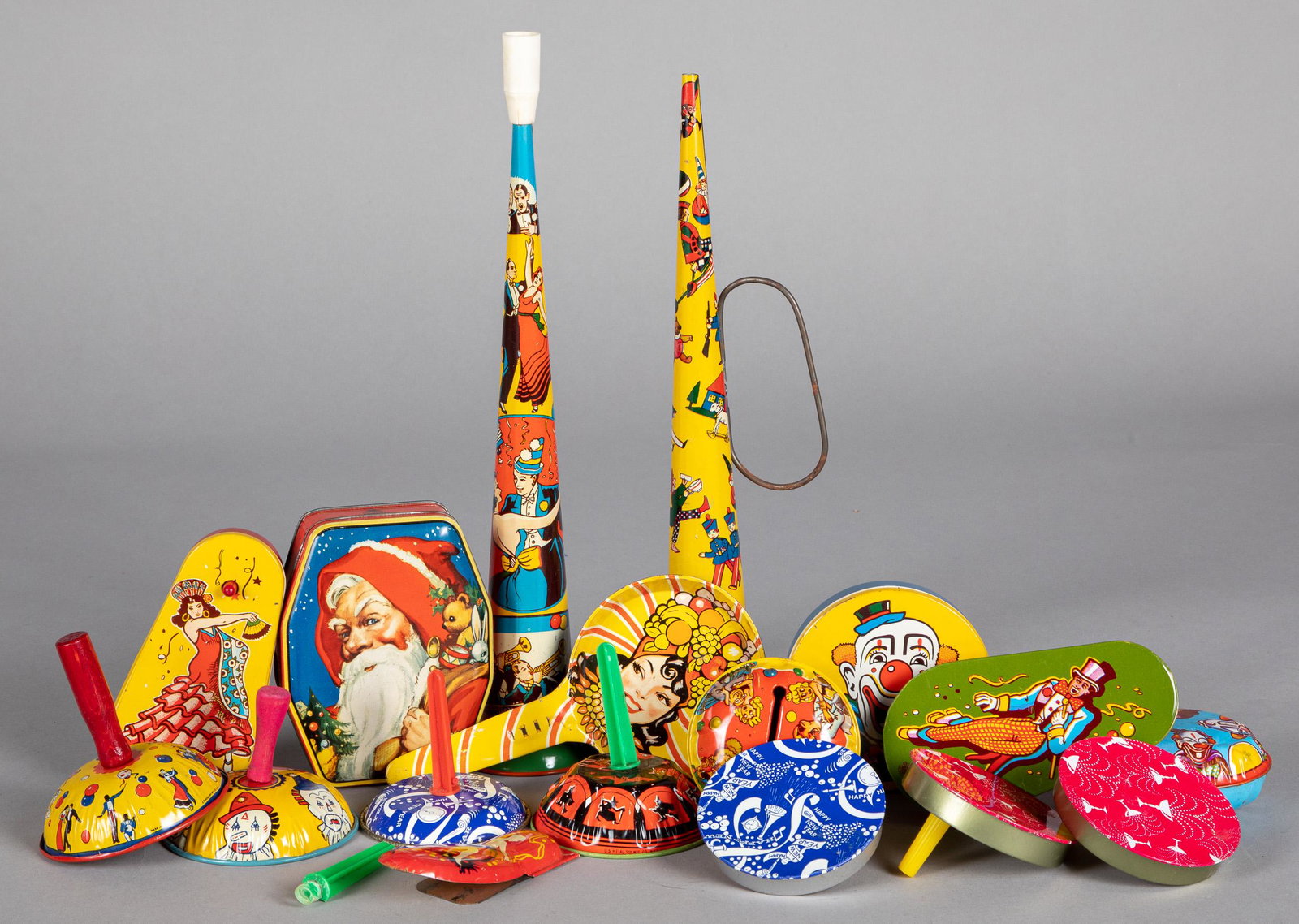 Group of tin lithograph holiday noise makers, etc: Collection of tin lithograph holiday noise makers, together with a candy box with Santa Claus, horns - 14 1/2'' l.