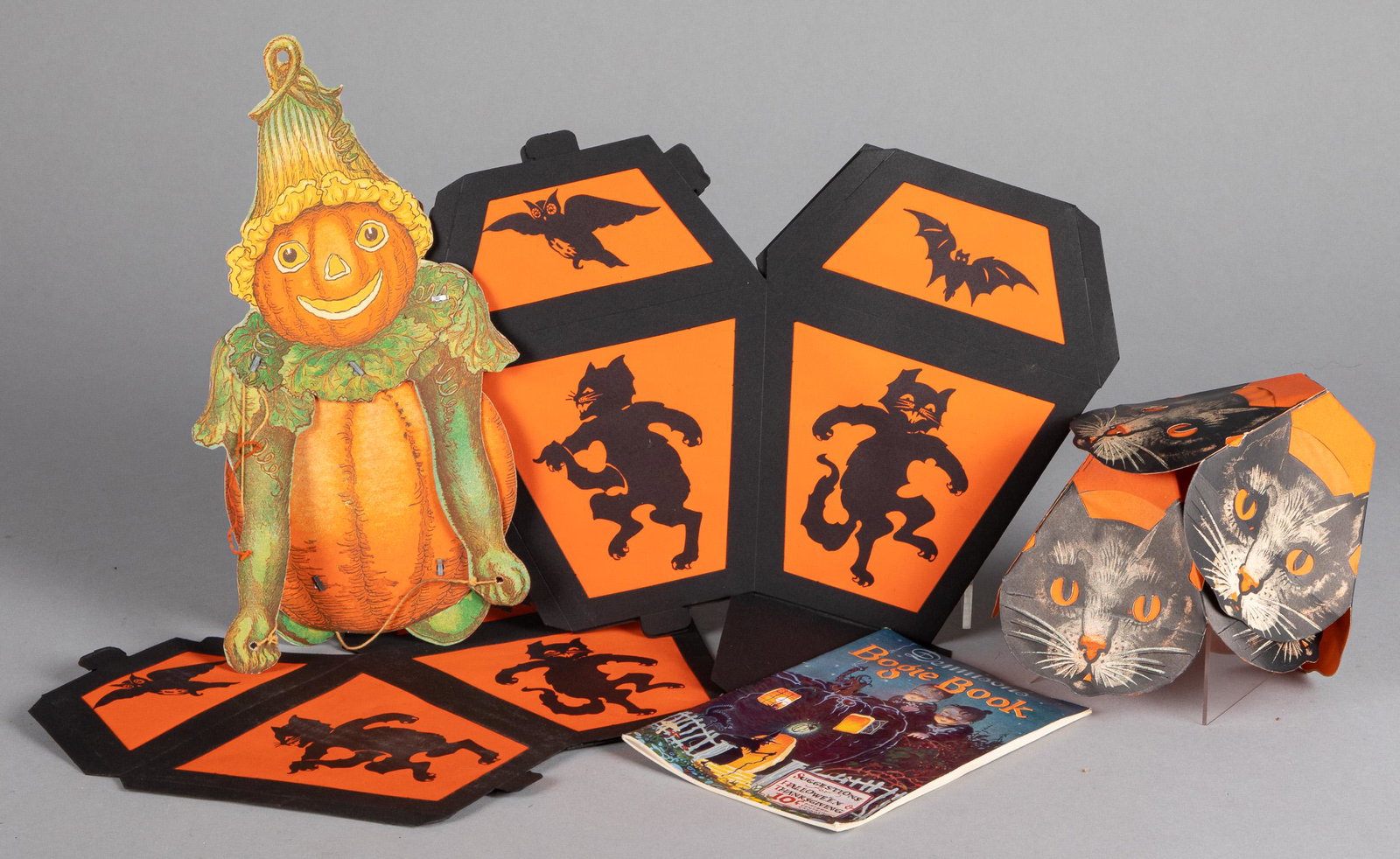 Group of vintage Halloween decorations: Group of vintage Halloween decorations, to include Boogie Book, two German cat lamp shades and paper carry buckets, shades - 5 1/4'' h., together with miscellaneous Christmas items.