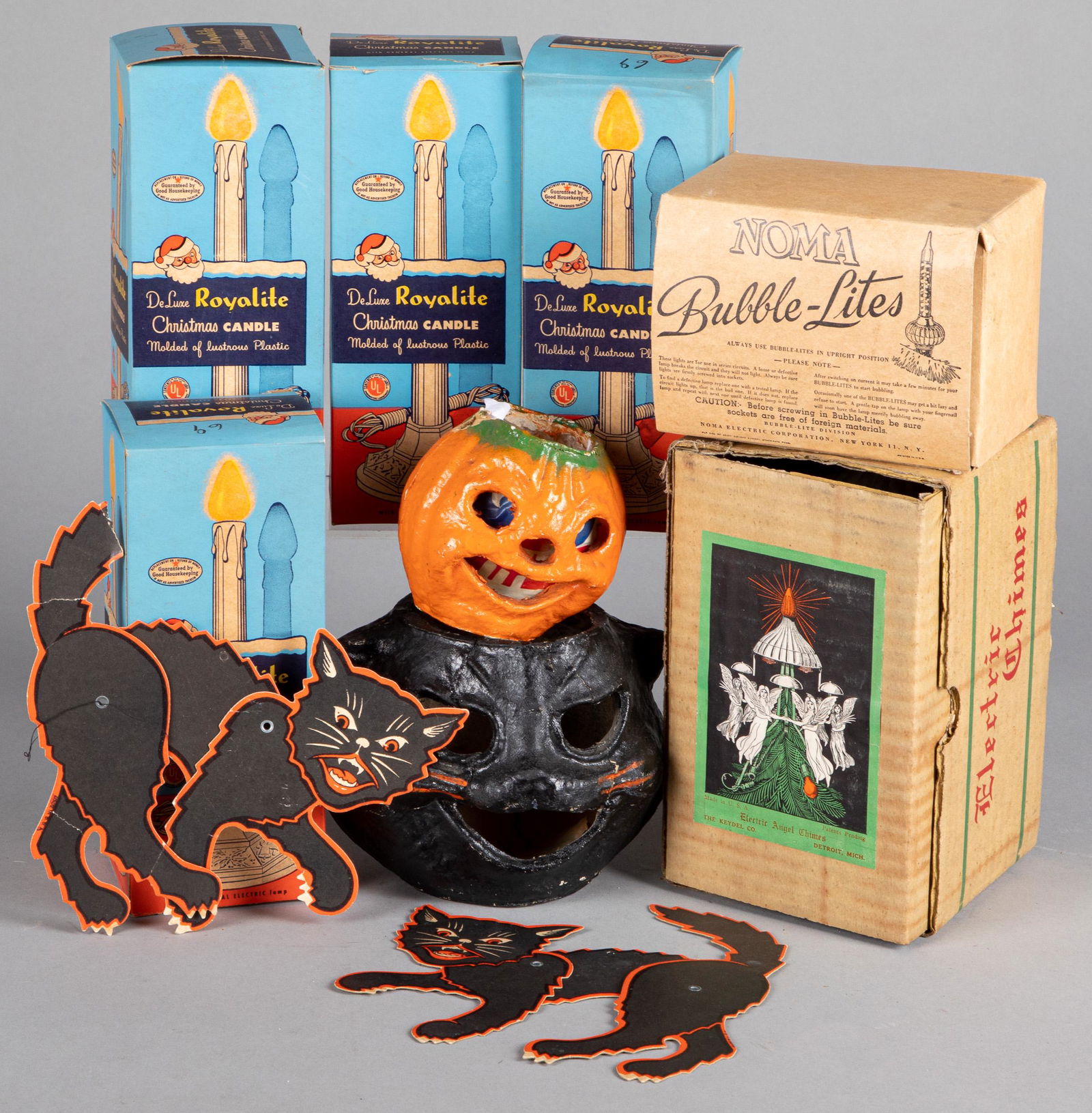 Two US paper pulp Jack-O-Lanterns, etc.: Two US paper pulp Jack-O-Lanterns, tallest - 5 1/2'' h.together with two die-cut cats, four Royalite Christmas candles, Noma Bubble-Lites, and Electric Angel Chimes.