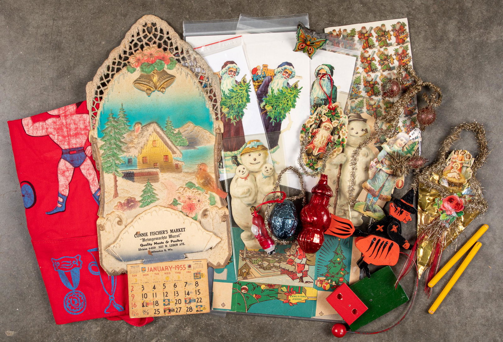 Group of Christmas items, etc.: Group of Christmas items, to include figural bulb, die-cuts, pressboard calendar, tinsel ornaments, etc., together with a child's Superman bib, and a contemporary Halloween witch balance toy.