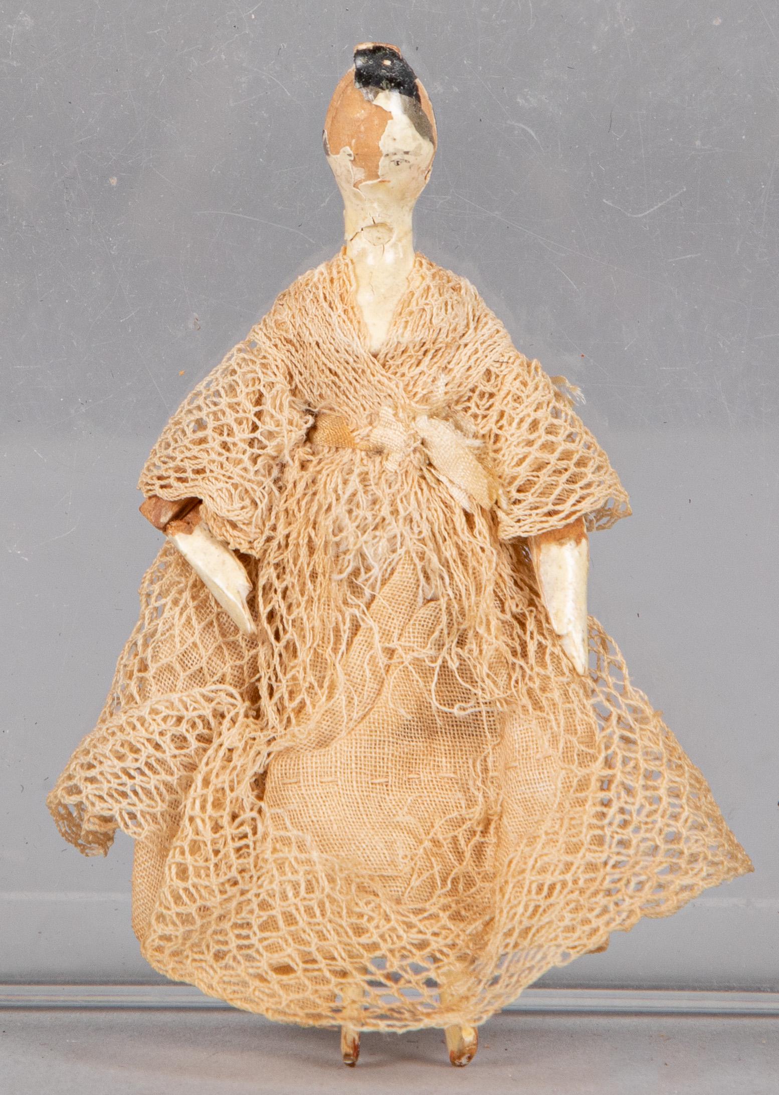 Miniature painted peg wooden doll: Miniature painted peg wooden doll, early 19th c., with original lace dress, 3 1/4'' h.