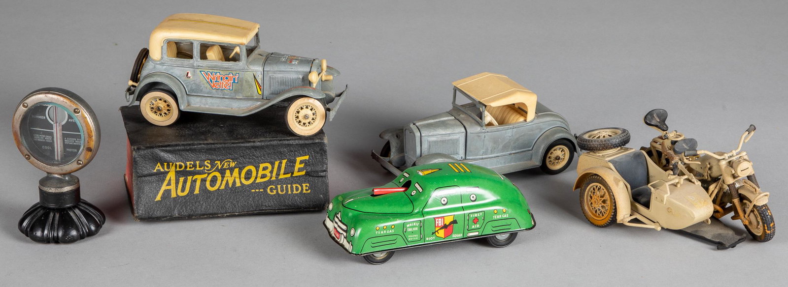 Miscellaneous car items and toys: Miscellaneous car items and toys, to include a Courtland tin lithograph friction FBI riot car, a Polistil military motorcycle, two Hubley cars, Boyce Motometer, and a 1954 Audels Automobile Guide.