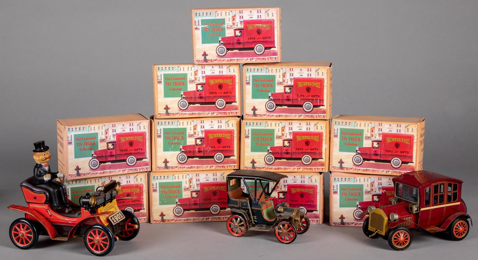Eleven Warner Bros. Old Fashioned Truck, etc.: Eleven tin lithograph Warner Bros. Old Fashioned Truck, in the original boxes, 7'' l., together with a Japanese tin lever action car, a battery operated car and a Rosko battery operated sedan.