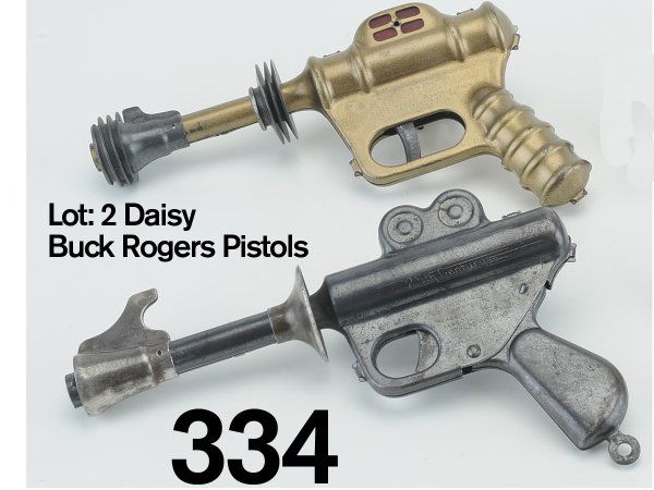 Lot: 2 Daisy Buck Rogers Pistols: pressed steel, includes an excellent example of the gold finished "Atomic Pistol" along with a very good example of the "Twenty Fifth Century" air gun in blued steel 9.5" l.